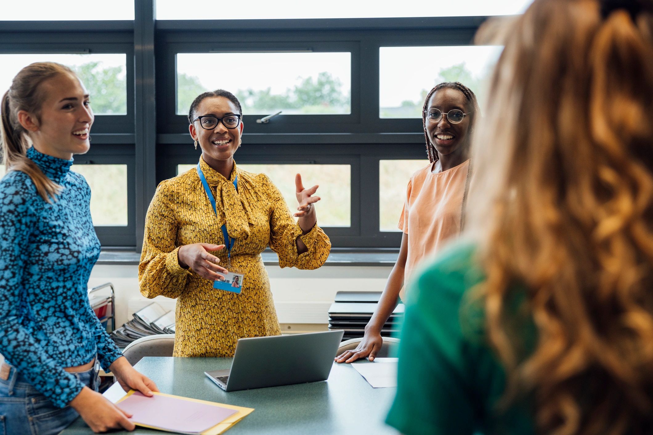 Teacher facilitating a discussion with students in a classroom