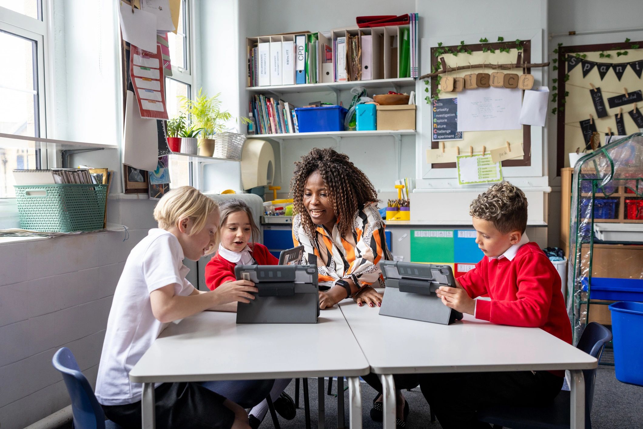 Teacher and students using digital tablets in class