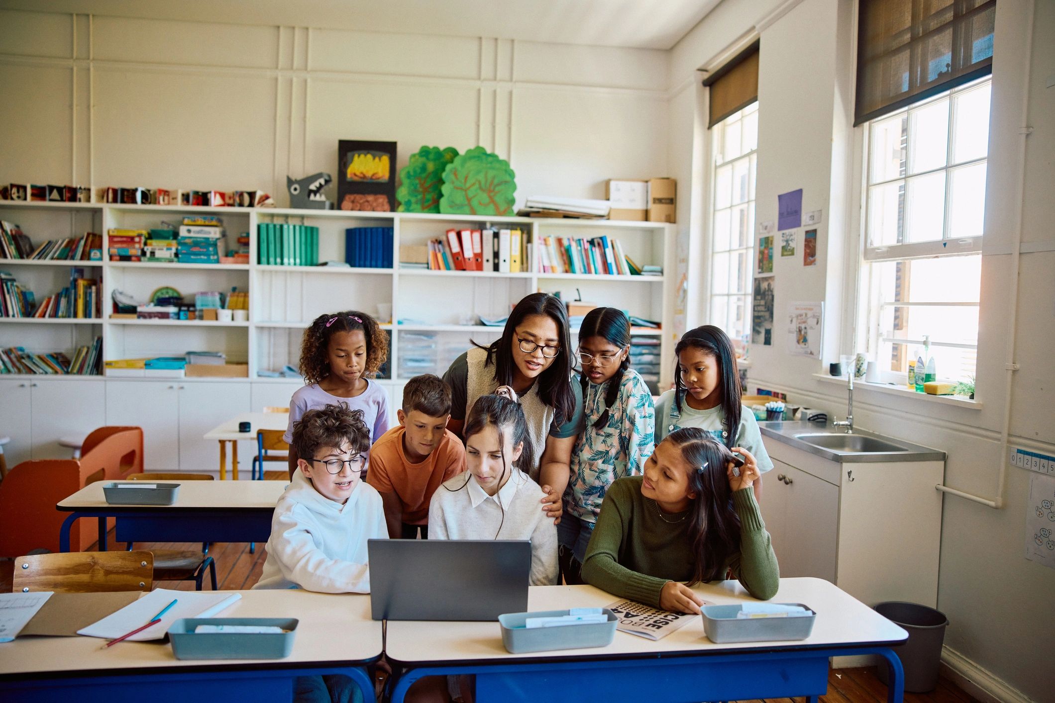 Students and teacher using technology in classroom